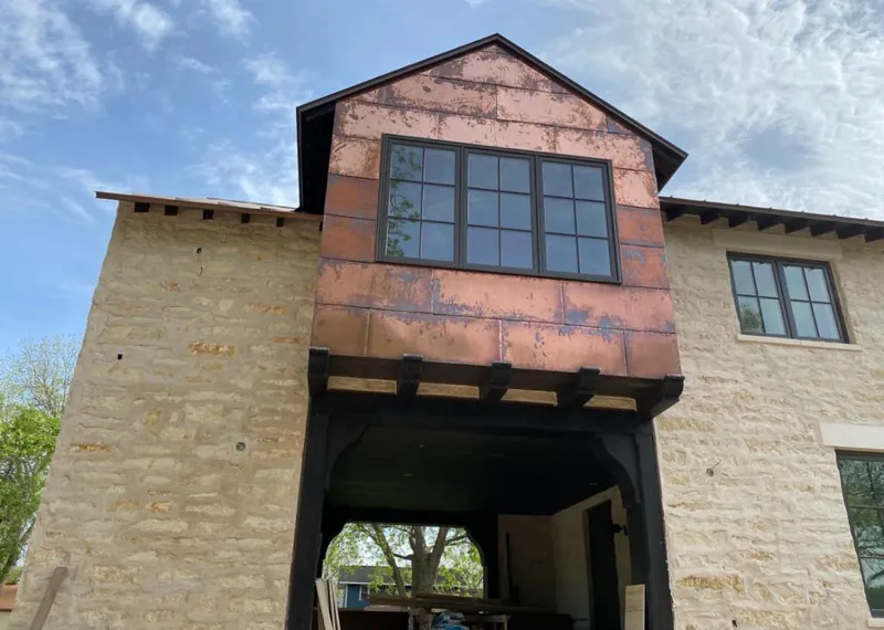 Copper metal panel facade on a stone building for Skylight Installation in Holdenville
