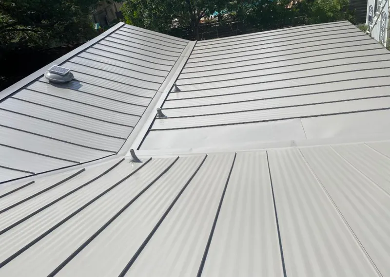 Solar attic fan installed on a metal roof for Roof Ventilation in Holdenville